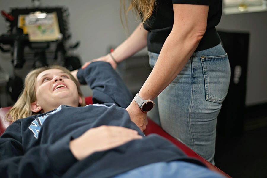 Chloe talking to a patient while performing prehab exercises