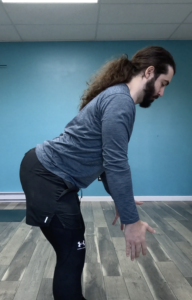 Dr. John overarching his low back causing back pain while bending forward. John showing an over arched back similar to how you'd see in lower crossed syndrome