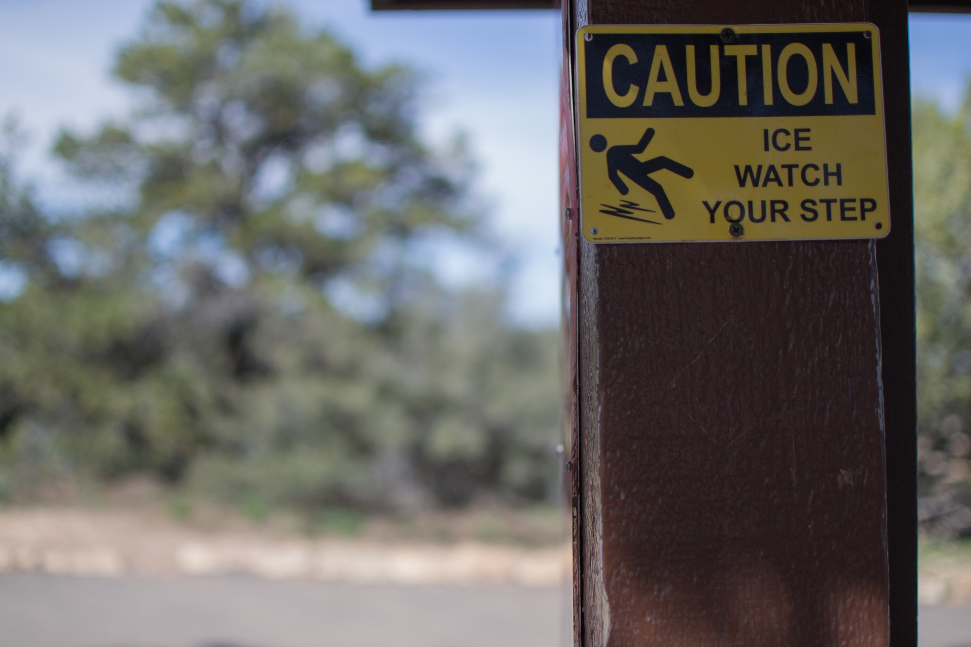 sign warning to be careful not to slip and cause back pain