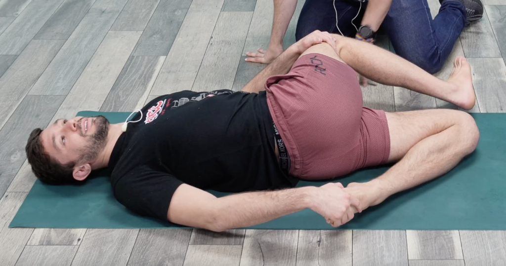 Rene demonstrating a twist to open up rotational spine mobility