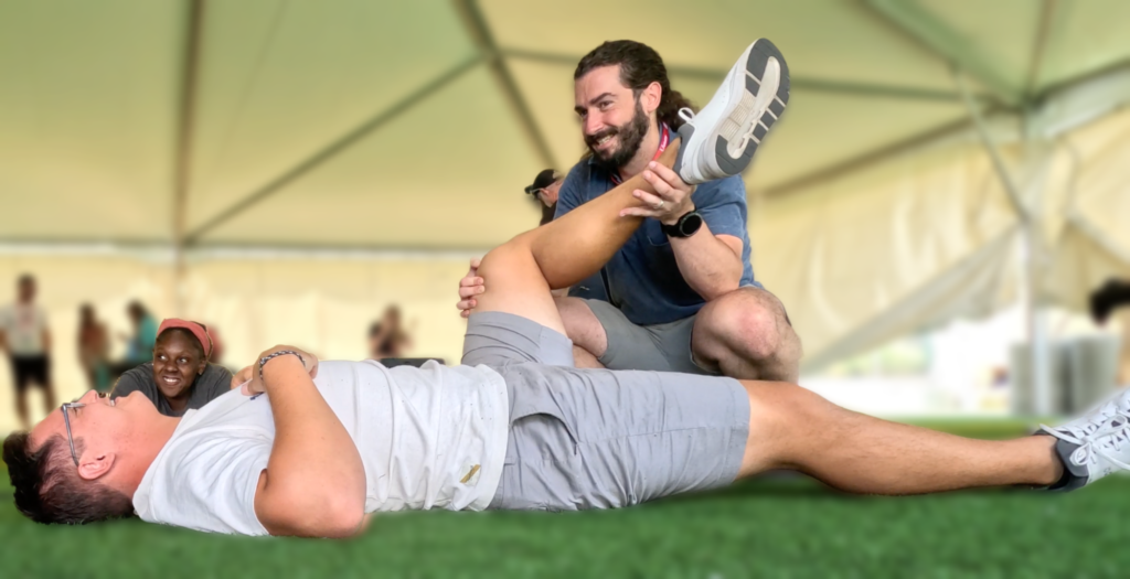 Dr. John doing recovery work on Rudy Winkler at US track and field Nationals before the world athletic championships event