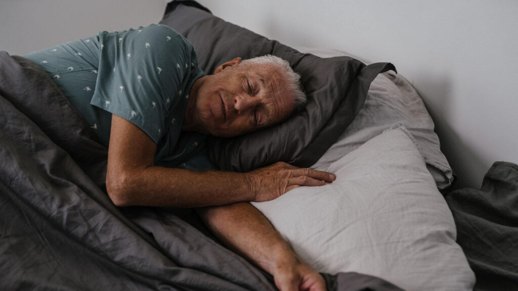 a man sleeping in his bed