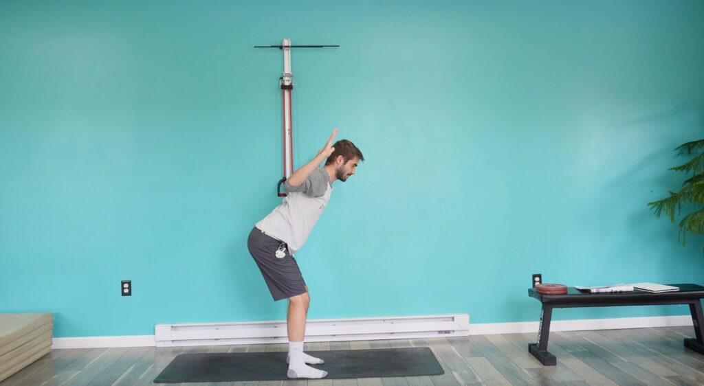 Dr. Jon in a hinged position with his elbows pulled down and back and his forearms up in a W position for the YTW