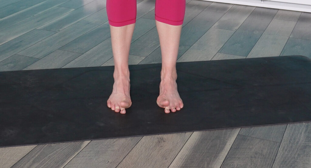 Dr. Chloe lifting her big toes and pressing the other 4 down for toe yoga