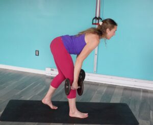 Dr. Chloe in a split stance hip hing position with her big toe lifted on her front foot. for toe yoga