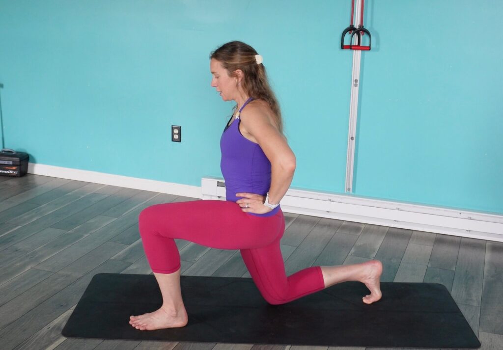 Dr. Chloe in a deep lunge with her left foot infront, big toe lifted doing toe yoga
