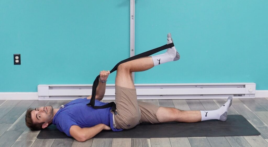 Dr. Jon with his leg bent showing he still has a slight arch in his back