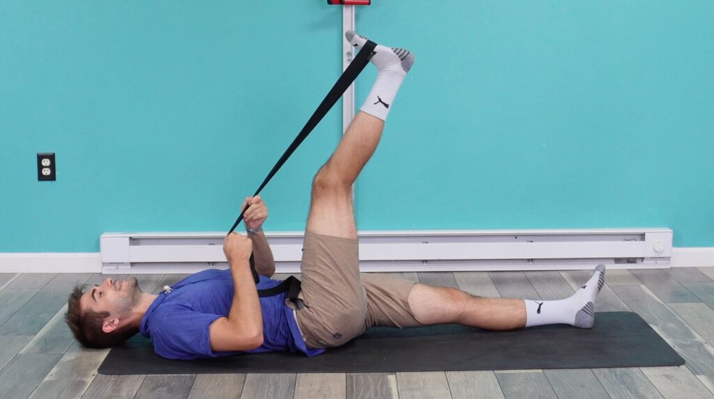 Dr. Jon demonstrating the leg being too high and not able to straighten the leg with a neutral back