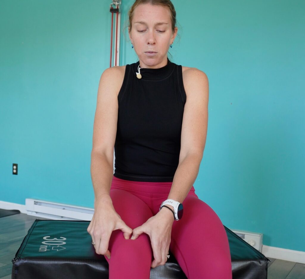 Dr. Chloe demonstrating the pin and stretch technique on her knee