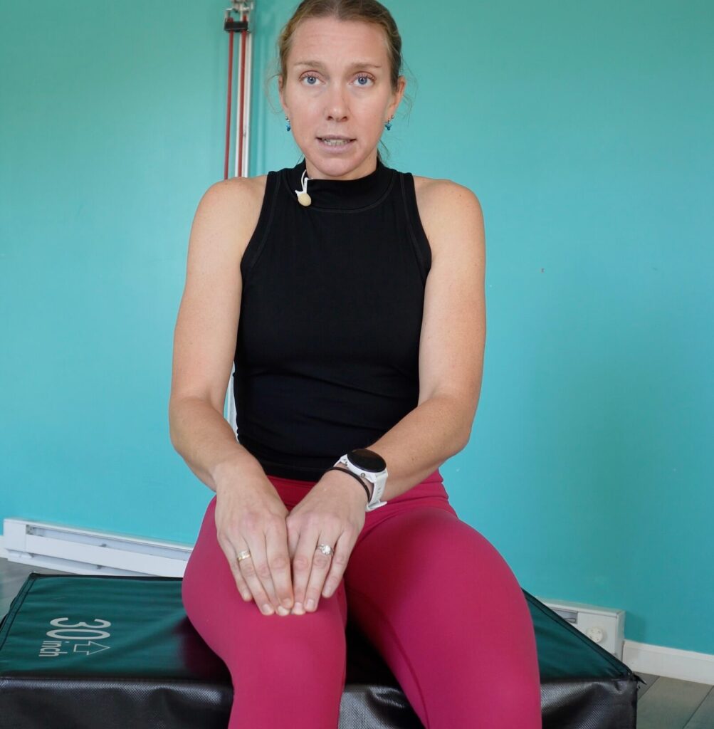 Dr. Chloe demonstrating a different way to do the pin and stretch technique on the knee by pulling up on her muscle while dynamically straightening her knee
