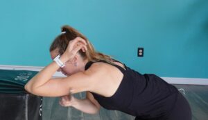 the 2nd version of tricep scraping for shoulder pain where you're in a stretching position on a bench or chair