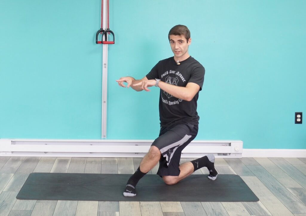 Dr. John demonstrating having his hips open for the curtsy squat
