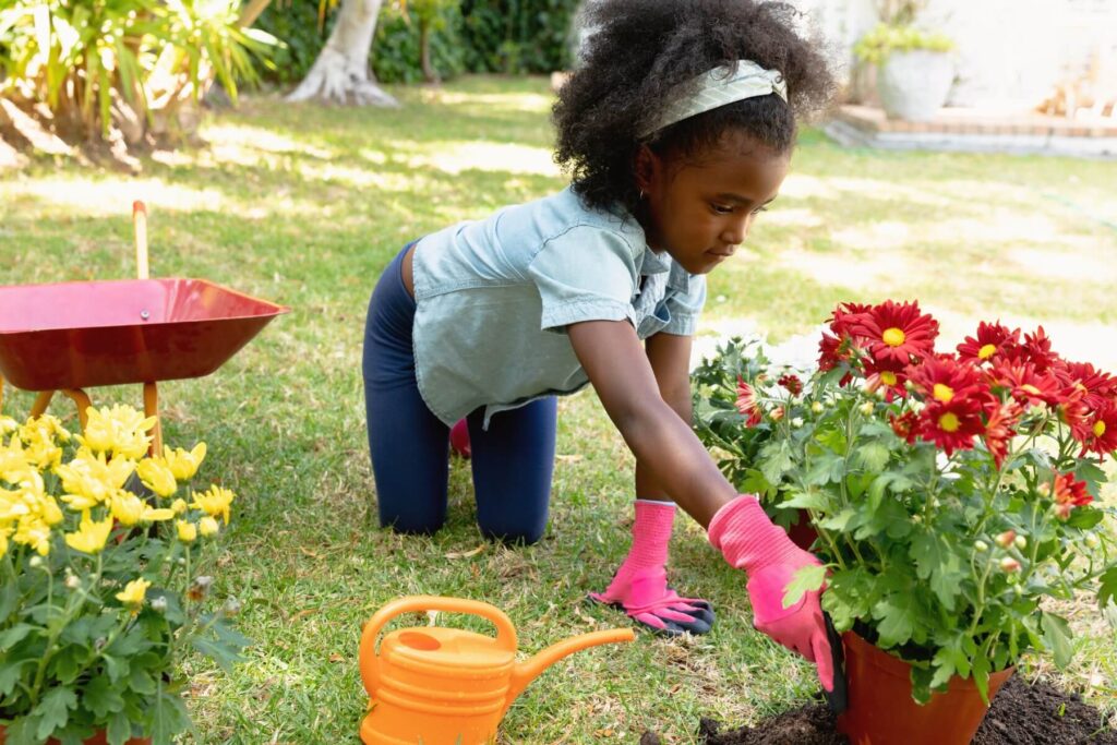 a little girl gardening but twisting while trying to plant - which could result in back pain from gardening